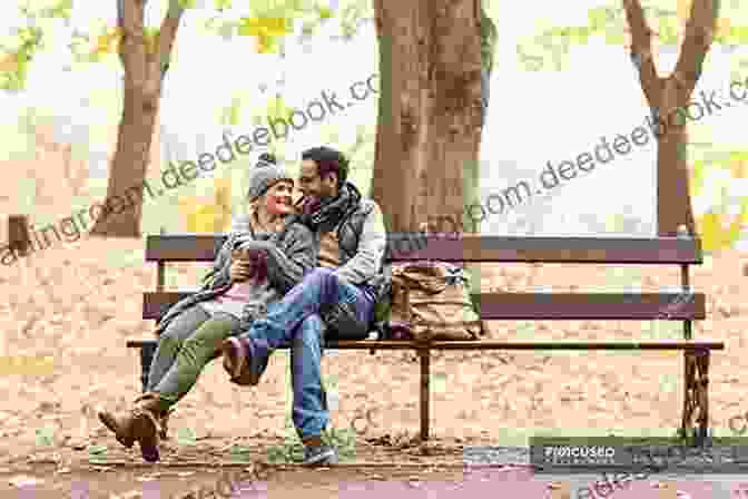 A Man And A Woman Sitting On A Park Bench, Holding Hands. The Woman Is Looking Up At The Man With A Smile. DATING FOR THE MODERN MAN: Simple Things Women Want Men To Understand